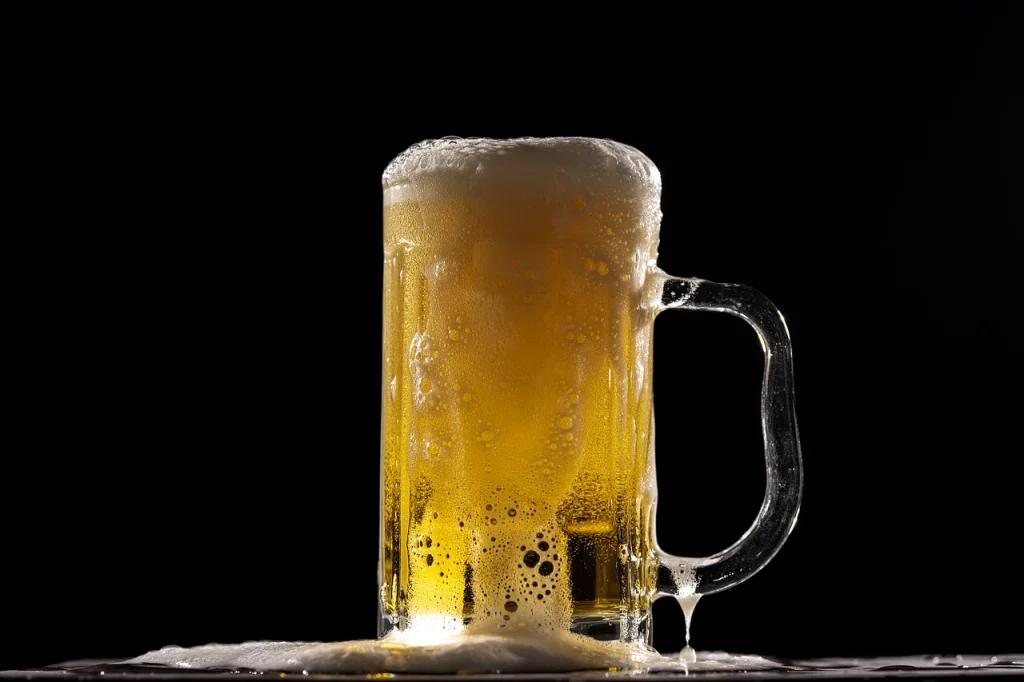 This image shows a foaming glass of beer.