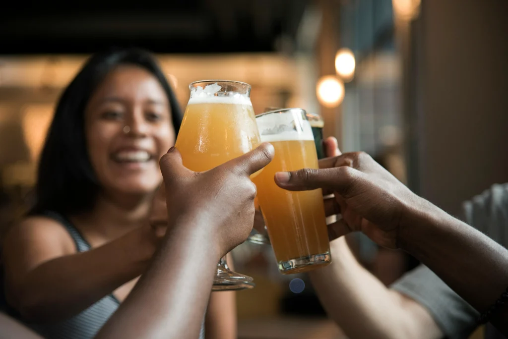 This image shows a group of people toasting with glasses of beer.