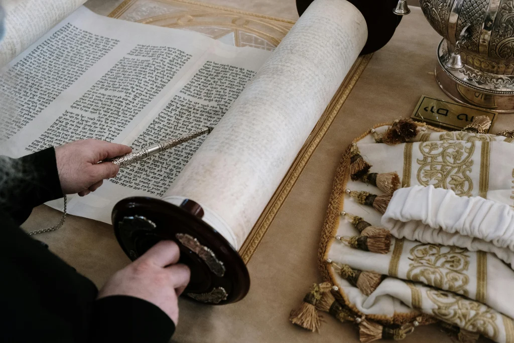 This image shows a man reading the Torah in Biblical Hebrew.